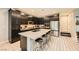 Contemporary kitchen with a spacious island, stainless steel appliances, and dark cabinetry for a sleek design at 707 Cottonwood Hill Pl, Henderson, NV 89011