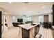 Bright, open-concept kitchen featuring a large island with bar seating, and seamless transition to the living room at 707 Cottonwood Hill Pl, Henderson, NV 89011