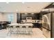 Modern kitchen features island with seating, stainless steel appliances, and ample counter space for cooking at 707 Cottonwood Hill Pl, Henderson, NV 89011