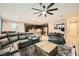 Open-concept living room showcasing leather seating, a central coffee table, and seamless flow to the kitchen at 707 Cottonwood Hill Pl, Henderson, NV 89011