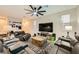Comfortable living room with plush leather seating, ceiling fan, and entertainment center for a relaxing atmosphere at 707 Cottonwood Hill Pl, Henderson, NV 89011