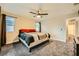 A cozy main bedroom features plush carpet, a ceiling fan, and neutral decor for a relaxing retreat at 707 Cottonwood Hill Pl, Henderson, NV 89011