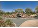 Fun playground feature with a tunnel running through a mound of rocks and plants at 707 Cottonwood Hill Pl, Henderson, NV 89011