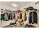This is a crowded walk-in closet with hanging clothes, shelves, boxes and bags at 707 Cottonwood Hill Pl, Henderson, NV 89011