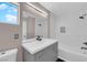 Bright bathroom featuring a gray vanity, framed mirror and a shower-tub combo at 720 Picasso Picture Ct, North Las Vegas, NV 89081