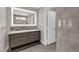 Bathroom featuring a dual sink vanity with a decorative mirror and lighting and a separate water closet at 720 Picasso Picture Ct, North Las Vegas, NV 89081