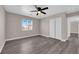Bedroom featuring wood-look floors, ceiling fan, window and double sliding door closet at 720 Picasso Picture Ct, North Las Vegas, NV 89081