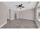 Large bedroom featuring tiled floors, a ceiling fan, and doorway leading to an ensuite bath at 720 Picasso Picture Ct, North Las Vegas, NV 89081