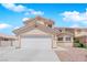 Charming two-story home showcasing a well-maintained front yard and inviting curb appeal with a garage and driveway at 720 Picasso Picture Ct, North Las Vegas, NV 89081