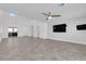 Expansive living area with neutral decor, tiled flooring, contemporary lighting, and access to additional rooms at 720 Picasso Picture Ct, North Las Vegas, NV 89081