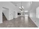 Spacious living room with high ceilings, tiled floors, modern lighting, and an open layout for versatile living at 720 Picasso Picture Ct, North Las Vegas, NV 89081