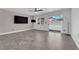 Open-concept living room with sleek tiled flooring, large windows, and a minimalist aesthetic perfect for relaxation at 720 Picasso Picture Ct, North Las Vegas, NV 89081