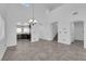 Elegant living area with high ceilings, tiled flooring, and seamless flow into the kitchen and other areas at 720 Picasso Picture Ct, North Las Vegas, NV 89081