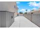 Narrow side yard with a concrete path and a storage shed leading to a gated entrance at 720 Picasso Picture Ct, North Las Vegas, NV 89081