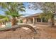 An inviting backyard with a pool, spa, palm trees, and covered patio at 7505 Java Sparrow St, North Las Vegas, NV 89084