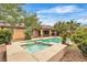 Backyard featuring pool with spa, covered patio, and lush landscaping at 7505 Java Sparrow St, North Las Vegas, NV 89084