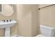 Bathroom features a pedestal sink and toilet at 7505 Java Sparrow St, North Las Vegas, NV 89084