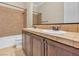 Bathroom with a dual sink vanity, bathtub and tile surround at 7505 Java Sparrow St, North Las Vegas, NV 89084
