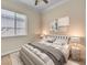 Cozy bedroom featuring neutral tones, plush bedding, and a window providing natural light at 7505 Java Sparrow St, North Las Vegas, NV 89084