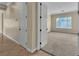 Bedroom doorway with carpeted floor, view to a window, and neutral colored walls at 7505 Java Sparrow St, North Las Vegas, NV 89084