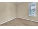 Carpeted bedroom with neutral walls and a window offering natural light at 7505 Java Sparrow St, North Las Vegas, NV 89084