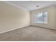 Spacious bedroom featuring neutral walls, carpet, baseboards and a bright window at 7505 Java Sparrow St, North Las Vegas, NV 89084