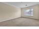 Neutral bedroom features large window, crown molding and plush carpeting at 7505 Java Sparrow St, North Las Vegas, NV 89084