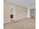 Large bedroom with neutral walls, carpet and doorways leading to other rooms at 7505 Java Sparrow St, North Las Vegas, NV 89084