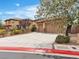 Charming two-story home with desert landscaping and a large three-car garage at 7505 Java Sparrow St, North Las Vegas, NV 89084
