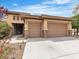 Well-maintained home featuring a two-car garage, desert landscaping, and a quaint covered entryway at 7505 Java Sparrow St, North Las Vegas, NV 89084
