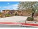 Charming home featuring a well-maintained front yard and a two-car garage, set against a clear sky at 7505 Java Sparrow St, North Las Vegas, NV 89084