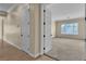Hallway with tile flooring leading to a carpeted bedroom at 7505 Java Sparrow St, North Las Vegas, NV 89084