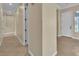Hallway featuring neutral walls, tile flooring, and a view of the front door at 7505 Java Sparrow St, North Las Vegas, NV 89084