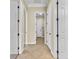 Tiled hallway with multiple doors, leading to various rooms within the home at 7505 Java Sparrow St, North Las Vegas, NV 89084
