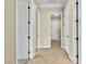 Hallway featuring neutral walls, tile flooring, and classic white doors at 7505 Java Sparrow St, North Las Vegas, NV 89084
