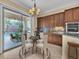 Elegant eat-in kitchen features wood cabinets, granite counters, and views of the outdoor pool and patio area at 7505 Java Sparrow St, North Las Vegas, NV 89084