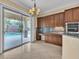 Elegant kitchen boasts wood cabinets, granite counters, and outdoor views at 7505 Java Sparrow St, North Las Vegas, NV 89084