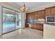 Bright kitchen features custom cabinets, granite counters and a view of the backyard pool at 7505 Java Sparrow St, North Las Vegas, NV 89084