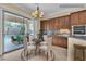 Bright kitchen features custom cabinets, granite counters and a view of the backyard pool at 7505 Java Sparrow St, North Las Vegas, NV 89084
