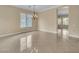 Spacious living room with tile floors, natural light and contemporary chandelier at 7505 Java Sparrow St, North Las Vegas, NV 89084