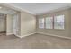 The spacious living room has tile floors and three large windows at 7505 Java Sparrow St, North Las Vegas, NV 89084
