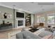 Staged living room with a modern fireplace, stylish decor, and ample natural light at 7505 Java Sparrow St, North Las Vegas, NV 89084