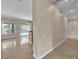 Hallway with tile floors leading to an open living space with a sliding door to the outside at 7505 Java Sparrow St, North Las Vegas, NV 89084