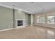 Spacious living room with a fireplace, neutral walls, and tile flooring at 7505 Java Sparrow St, North Las Vegas, NV 89084