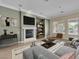 Staged living room with contemporary decor, fireplace, and large windows at 7505 Java Sparrow St, North Las Vegas, NV 89084