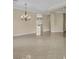 Spacious living room with tile floors, natural light and contemporary chandelier at 7505 Java Sparrow St, North Las Vegas, NV 89084