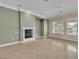 Open living space with tiled floors, fireplace, and large windows providing natural light at 7505 Java Sparrow St, North Las Vegas, NV 89084