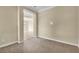 Open living space showcasing neutral walls and carpet, with a doorway to another room at 7505 Java Sparrow St, North Las Vegas, NV 89084