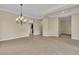 Spacious living room with tile floors and neutral paint, illuminated by a decorative chandelier at 7505 Java Sparrow St, North Las Vegas, NV 89084