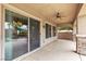 Covered patio area with ceiling fan, stone pillars, and sliding glass door at 7505 Java Sparrow St, North Las Vegas, NV 89084